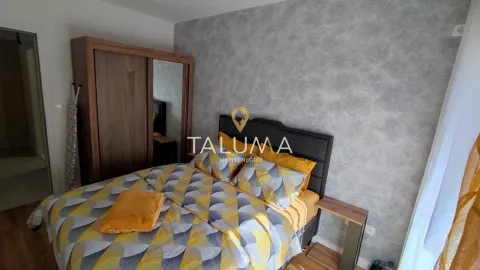 Furnished bedroom with a double bed, wardrobe, and a nightstand. - image 2