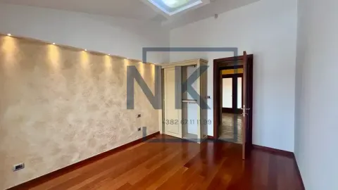 Empty bedroom with wooden flooring, wardrobe, and decorative wall lighting. - image 10