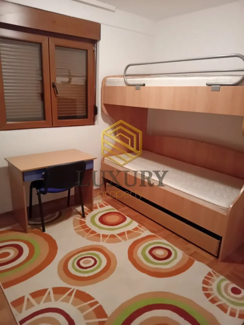 Children's bedroom with a bunk bed and a desk.