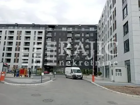 View of the courtyard and facade of an apartment building with an access road. - image 3
