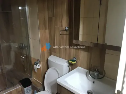 Compact bathroom with a shower cabin, sink, and toilet. - image 23