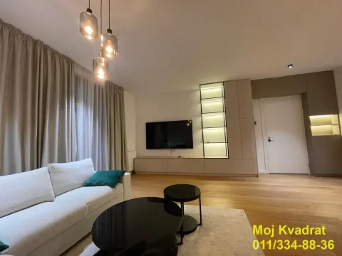 Living room with a sofa, TV, and modern lighting. - image 7