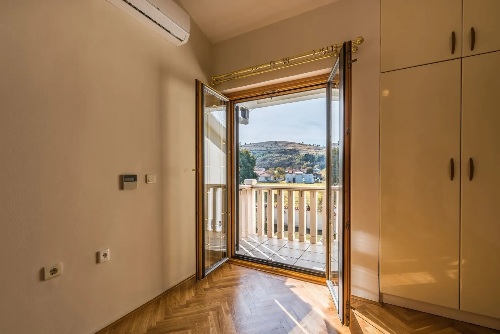 Bright room with balcony access and a scenic view.