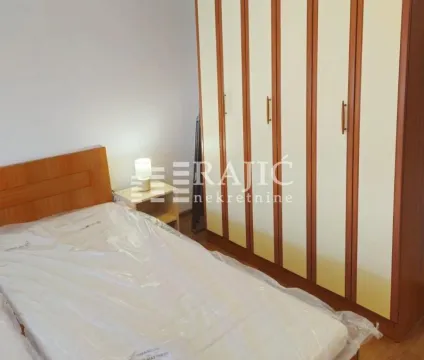 Furnished bedroom with a bed and a large wardrobe. - image 10