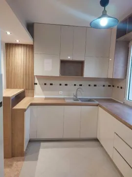Equipped kitchen with white cabinets and wooden countertops. - image 4