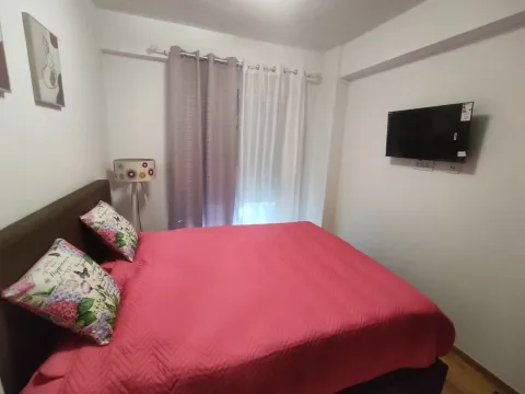 Bedroom with a double bed and a wall-mounted TV. - image 8