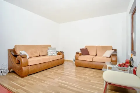 Living room with sofa set and hardwood flooring. - image 12