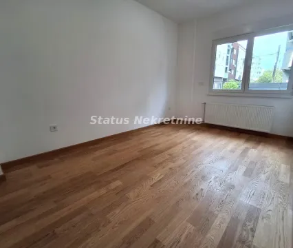 Empty room with wooden flooring and a window. - image 6