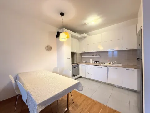 Modern white kitchen with a dining table and chairs. - image 4
