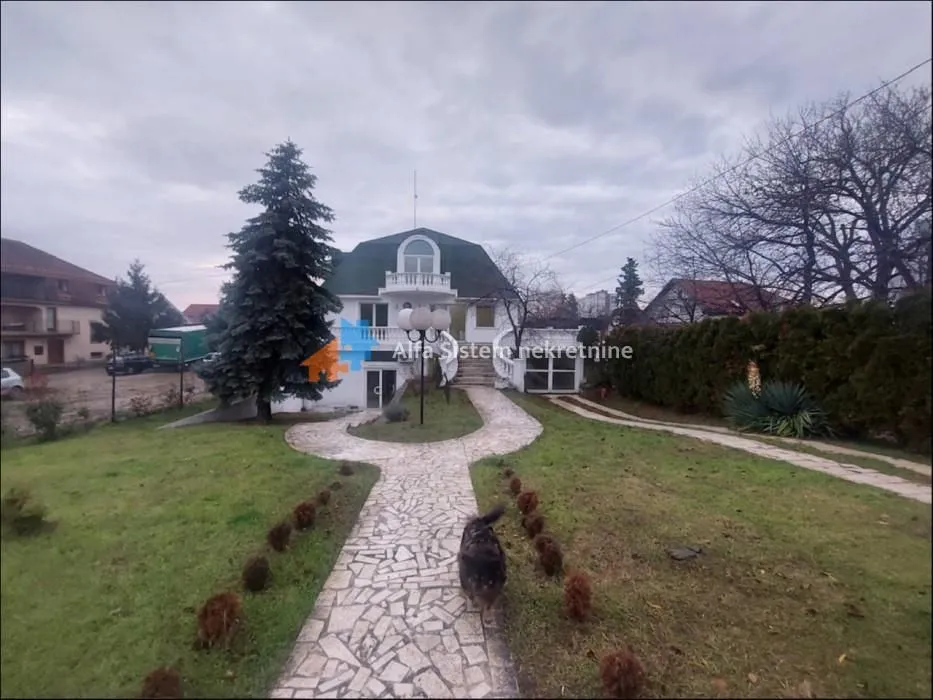 View of the house exterior with a landscaped yard and walkway.