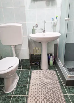 Bathroom with a sink, toilet and shower cabin. - image 5