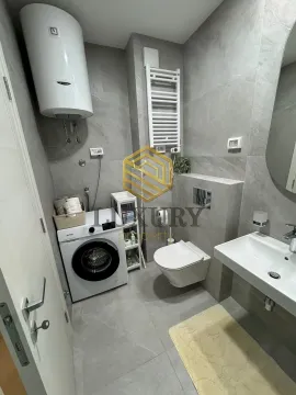Modernly equipped bathroom with a washing machine and water heater. - image 5