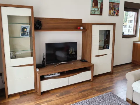 Living room with wooden furniture and a TV. - image 3