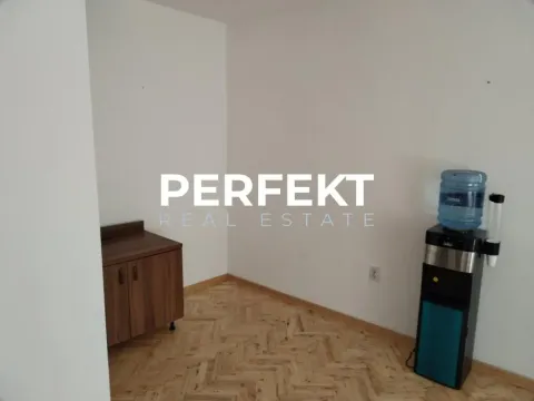 Empty room with parquet flooring and a water dispenser. - image 2