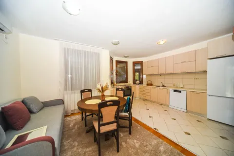 Open-plan kitchen with a dining area and a sofa. - image 4