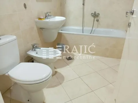 Fully equipped bathroom with a bathtub, sink, and sanitary fixtures. - image 12