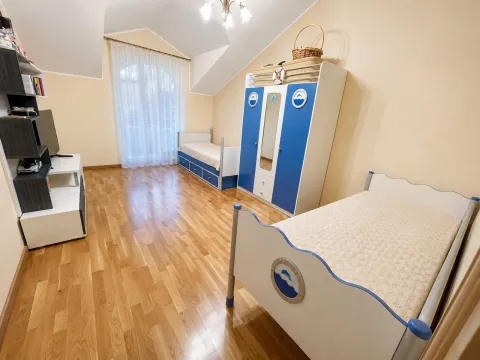 Children's bedroom with two beds, a wardrobe, and hardwood flooring. - image 10