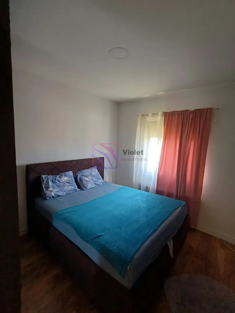 Bedroom with a double bed and a window.