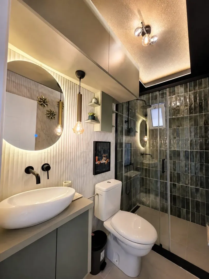 Modern bathroom with a sink, toilet, and walk-in shower.