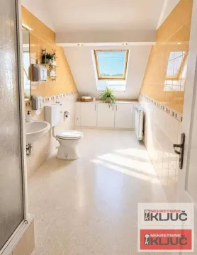 Bathroom with a shower cabin, toilet, washbasin, and a skylight window in the attic. - image 8