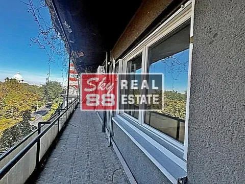 Spacious balcony with a view of greenery and the city street. - image 10