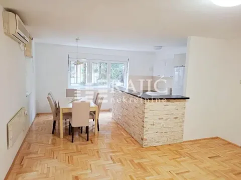 Spacious living room with dining area and a bar counter leading to the kitchen. - image 2