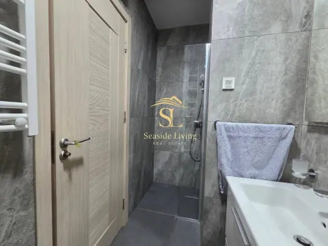 Modernly equipped bathroom with a shower cabin and washbasin. - image 12