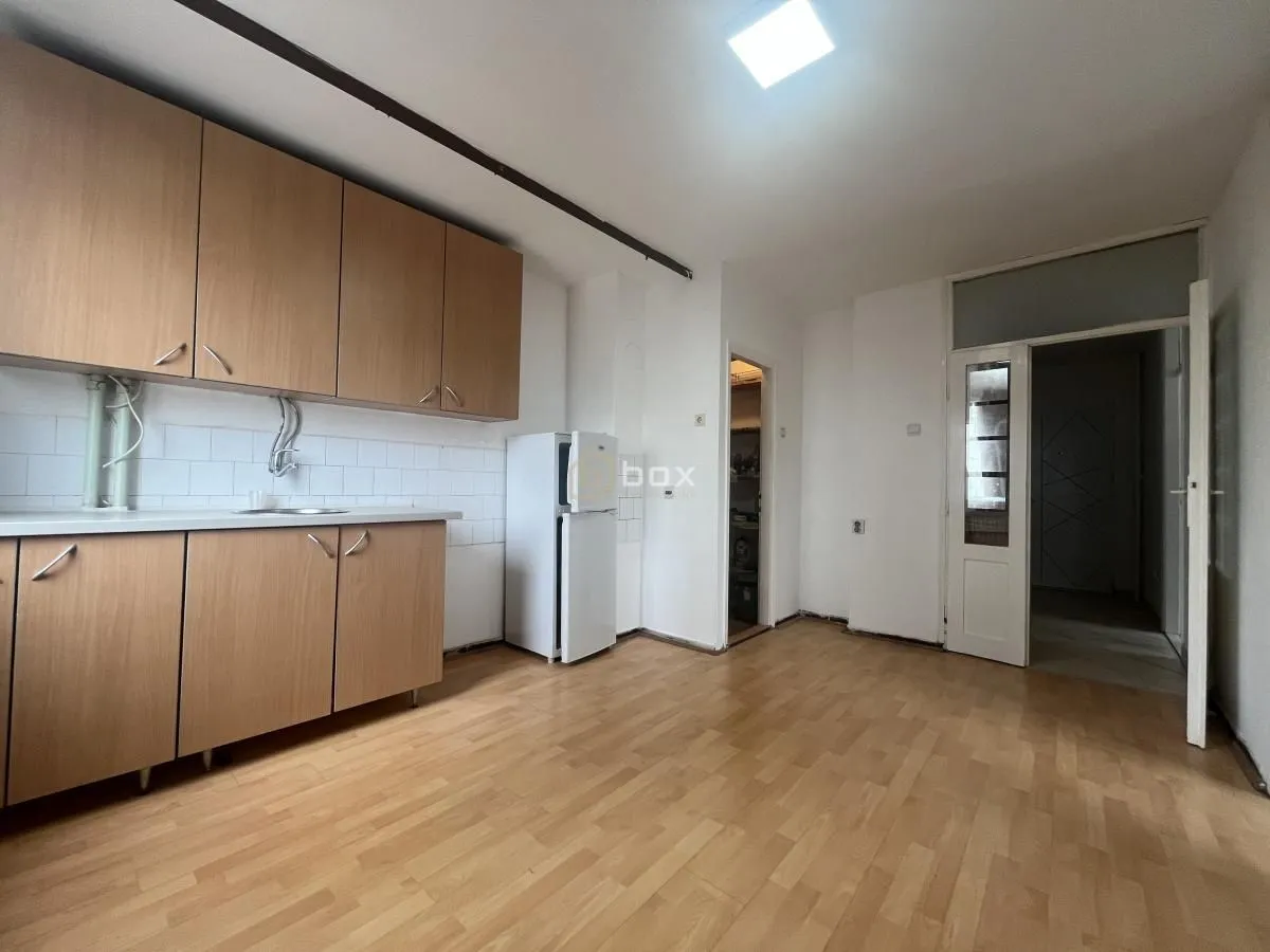 Kitchen with wooden cabinetry and a white refrigerator.