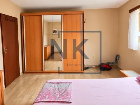 Bedroom with a large wooden wardrobe and a double bed. - image 14