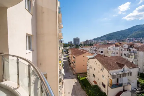 View from the balcony overlooking the city and surrounding buildings. - image 6