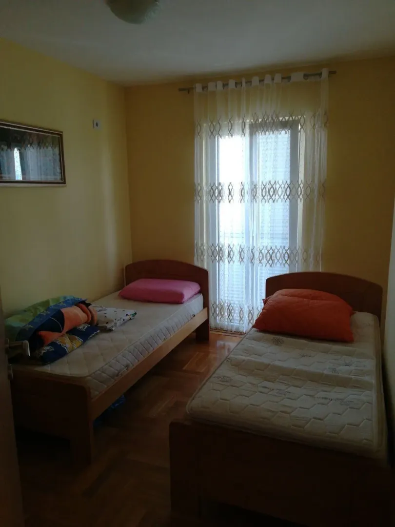 A simple bedroom with two single beds.