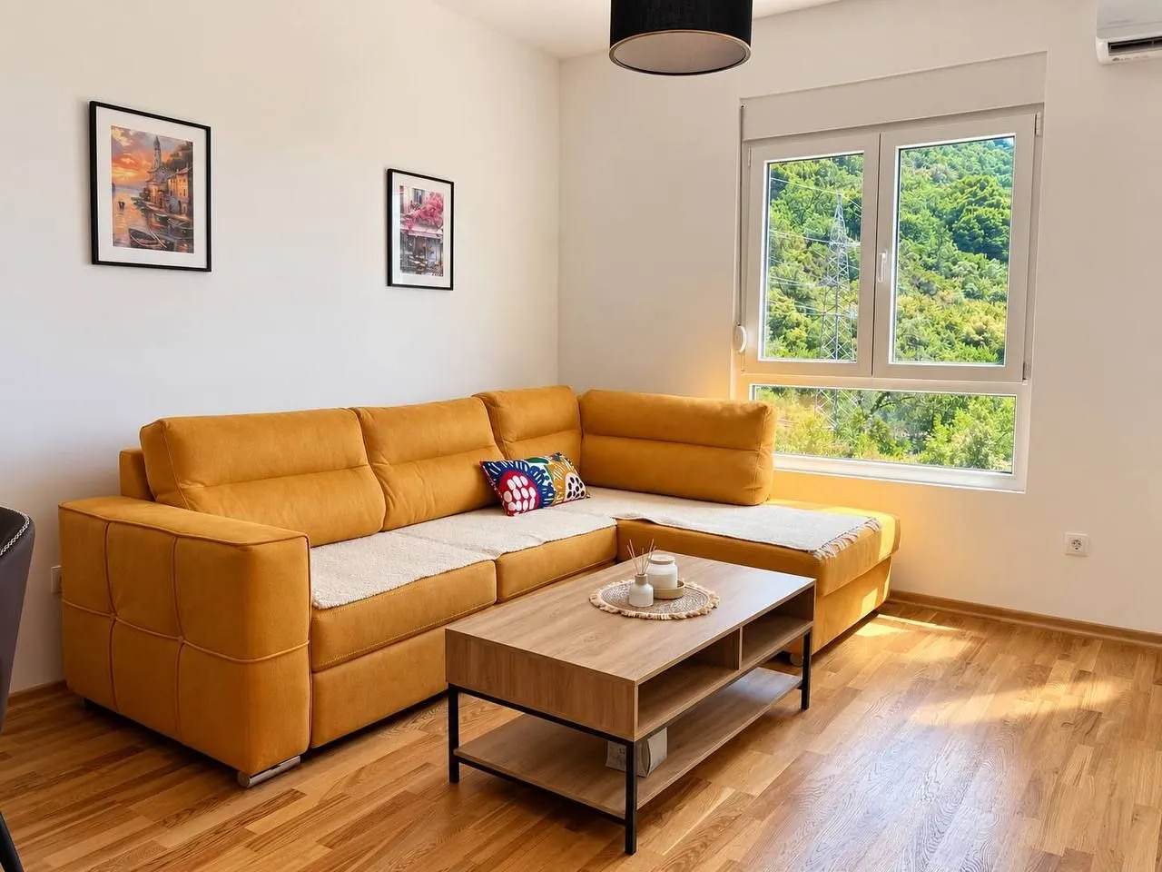 Living room with a yellow sectional sofa and a wooden coffee table.