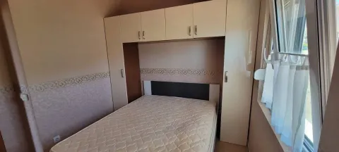 Furnished bedroom with a double bed and fitted wardrobes. - image 10