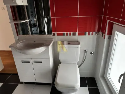 Small bathroom with white sanitary ware and red and white wall tiles. - image 9