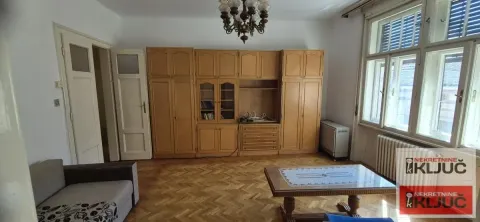 Dnevna soba sa drvenim nameštajem i parketom na podu. - image 7