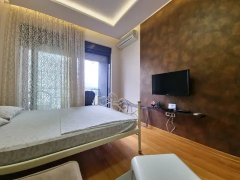 Bedroom with a double bed, TV, and access to the terrace. - image 8