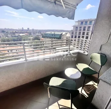 Furnished balcony with seating and city view. - image 12