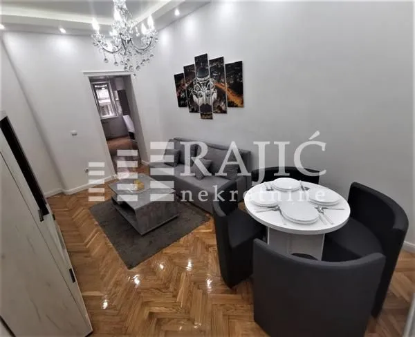 Living room with dining area and seating furniture.