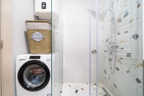 Modernly equipped bathroom with a shower cabin, washing machine, and water heater. - image 14