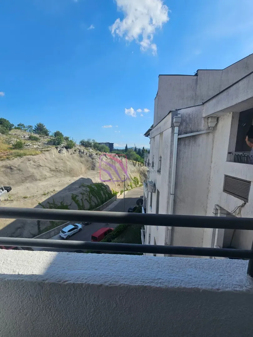 View from the balcony overlooking surrounding buildings and the street.