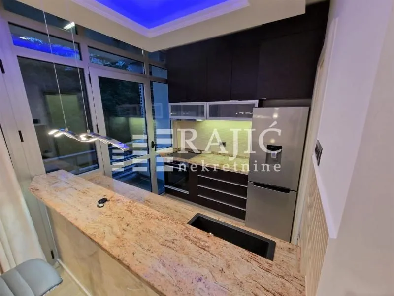 Modern kitchen with a bar counter and built-in appliances.