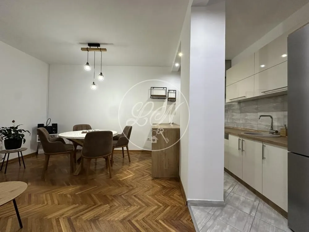 Open plan space with a kitchen and dining area.