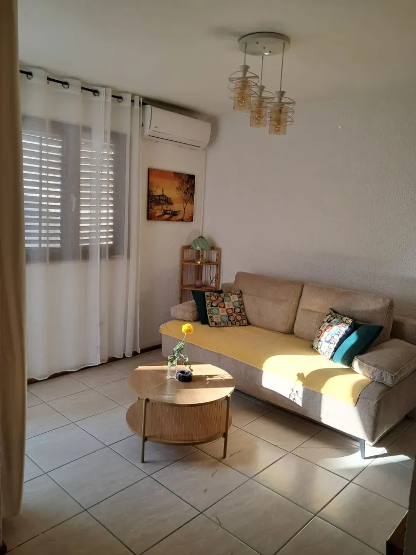 Bright living room with a sofa and a coffee table.
