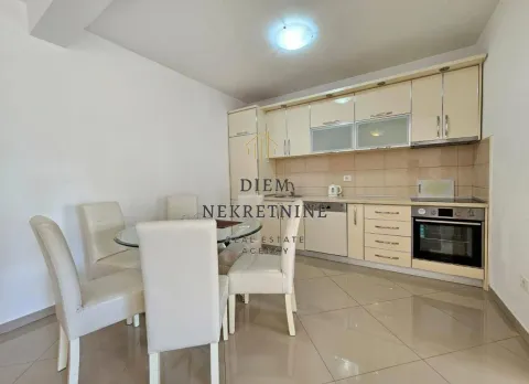 Modern kitchen with dining area in beige tones. - image 13