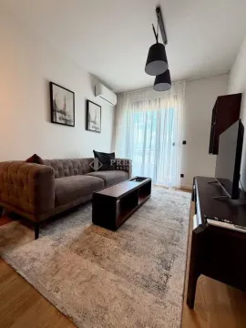 Modern and bright living room with a sofa and television. - image 4
