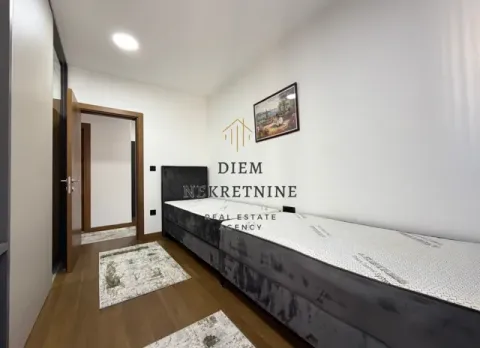 Moderna spavaća soba sa dva kreveta i drvenim podom. - image 8