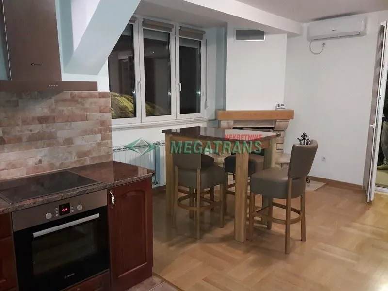 Kitchen connected to the dining area with built-in appliances.