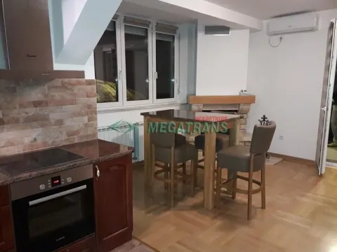 Kitchen connected to the dining area with built-in appliances. - image 3