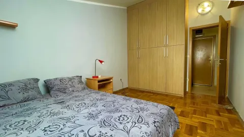 Furnished bedroom with a double bed, wardrobe, and nightstand. - image 6