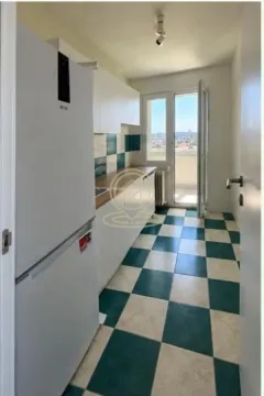 Small kitchen with white cabinets and a checkered floor. - image 6